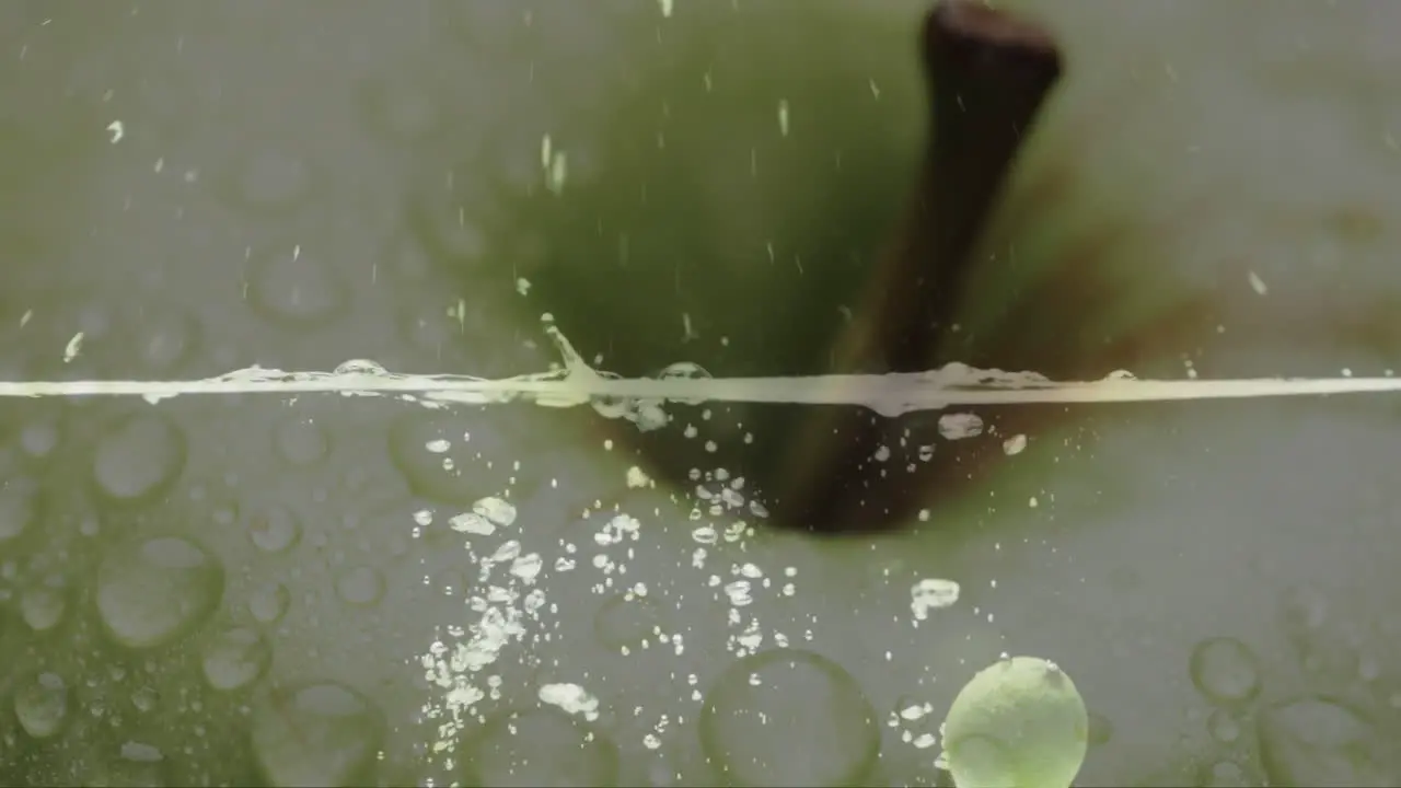 Composition of green apple over water bubbles