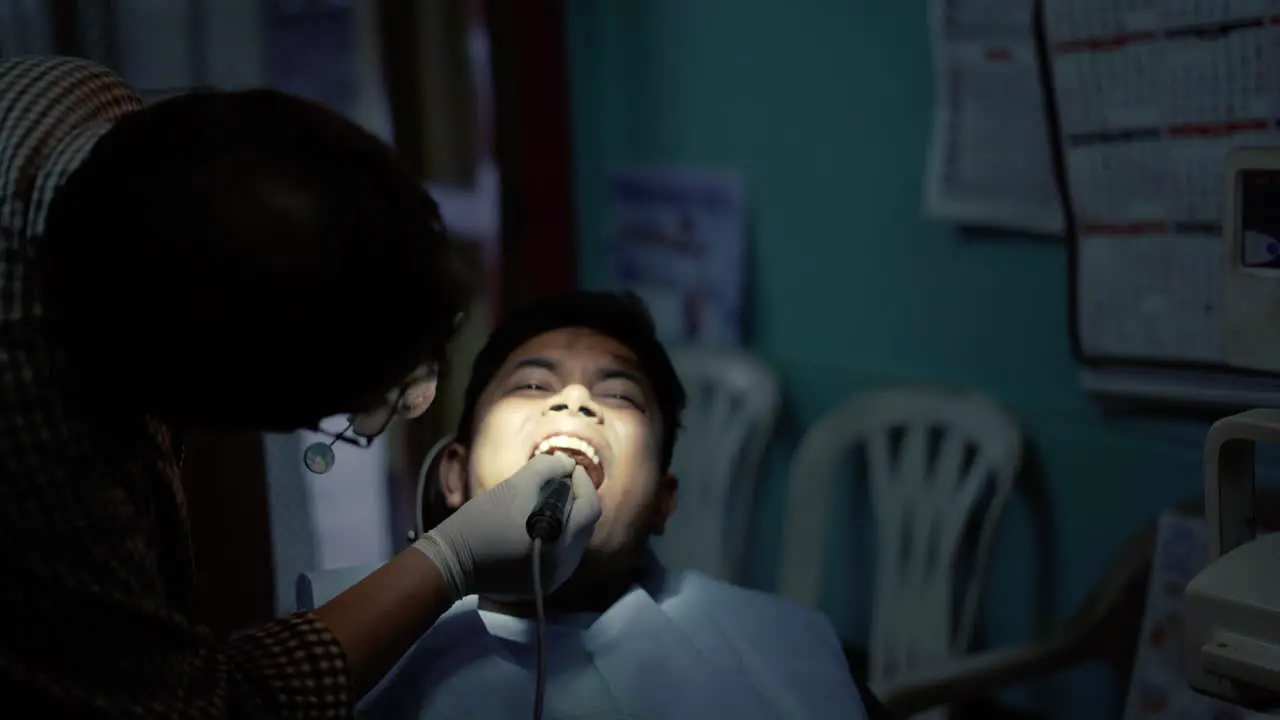 A Dentist Treating A Patient with Oral Prophylaxis Process