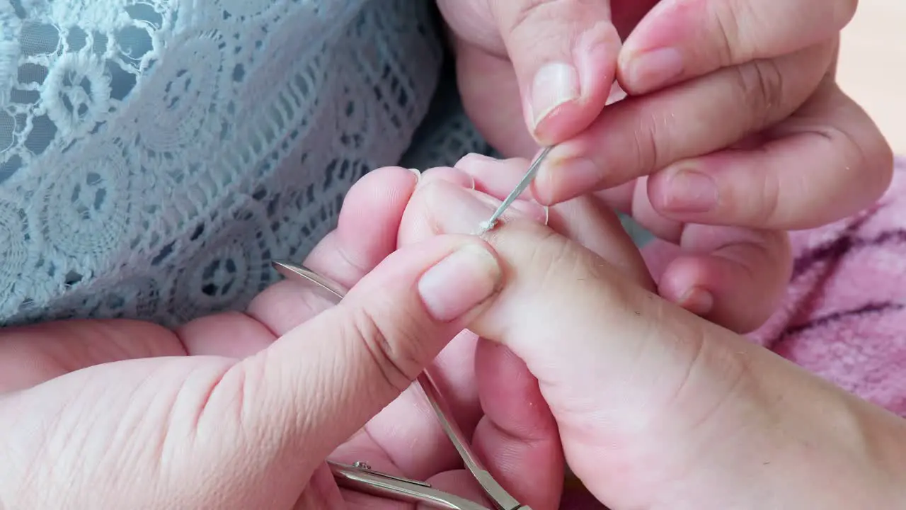 Cosmetologist beautician is making pedicures in cosmetology clinic using nippers-5