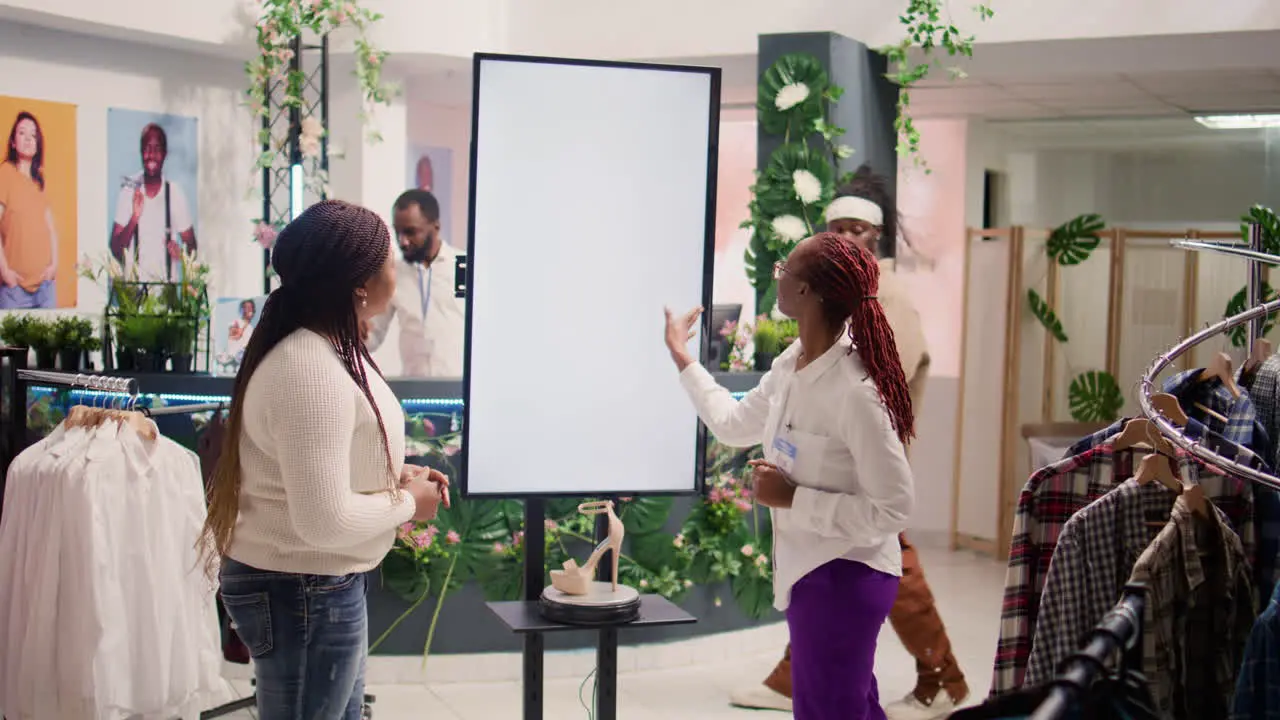 Second hand shop worker uses led kiosk