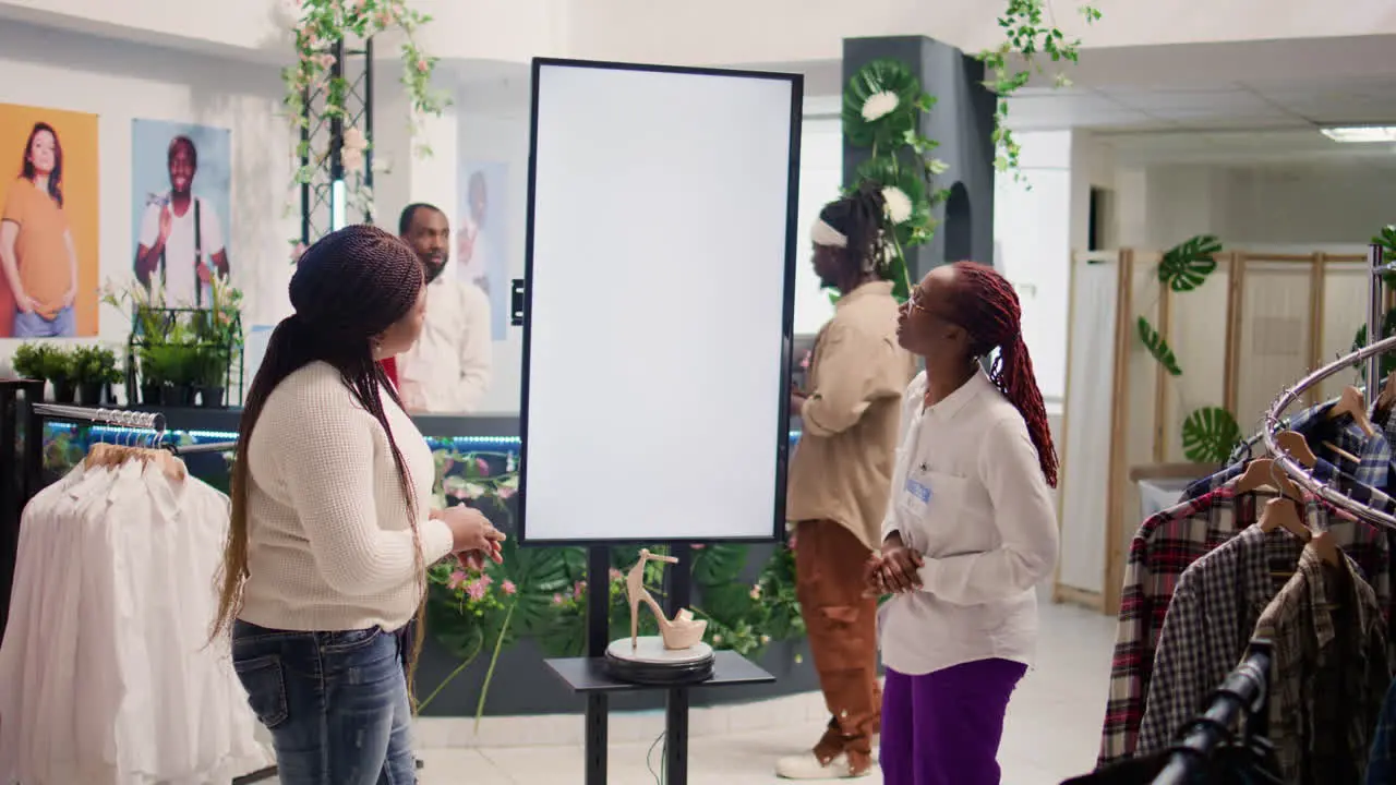 Woman uses screen to show client clothes