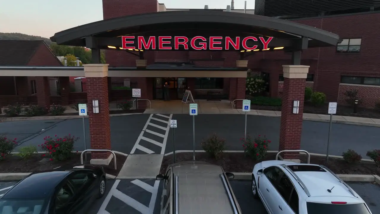 Zoom in aerial drone shot of emergency sign at emergency room in nice hospital building