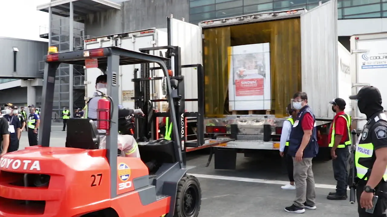 Covid-19 Vaccine Arrival An The Airport In The Philipines The Boxes Containing The Vaccines Are Being Moved And Placed Inside An Insulated Truck