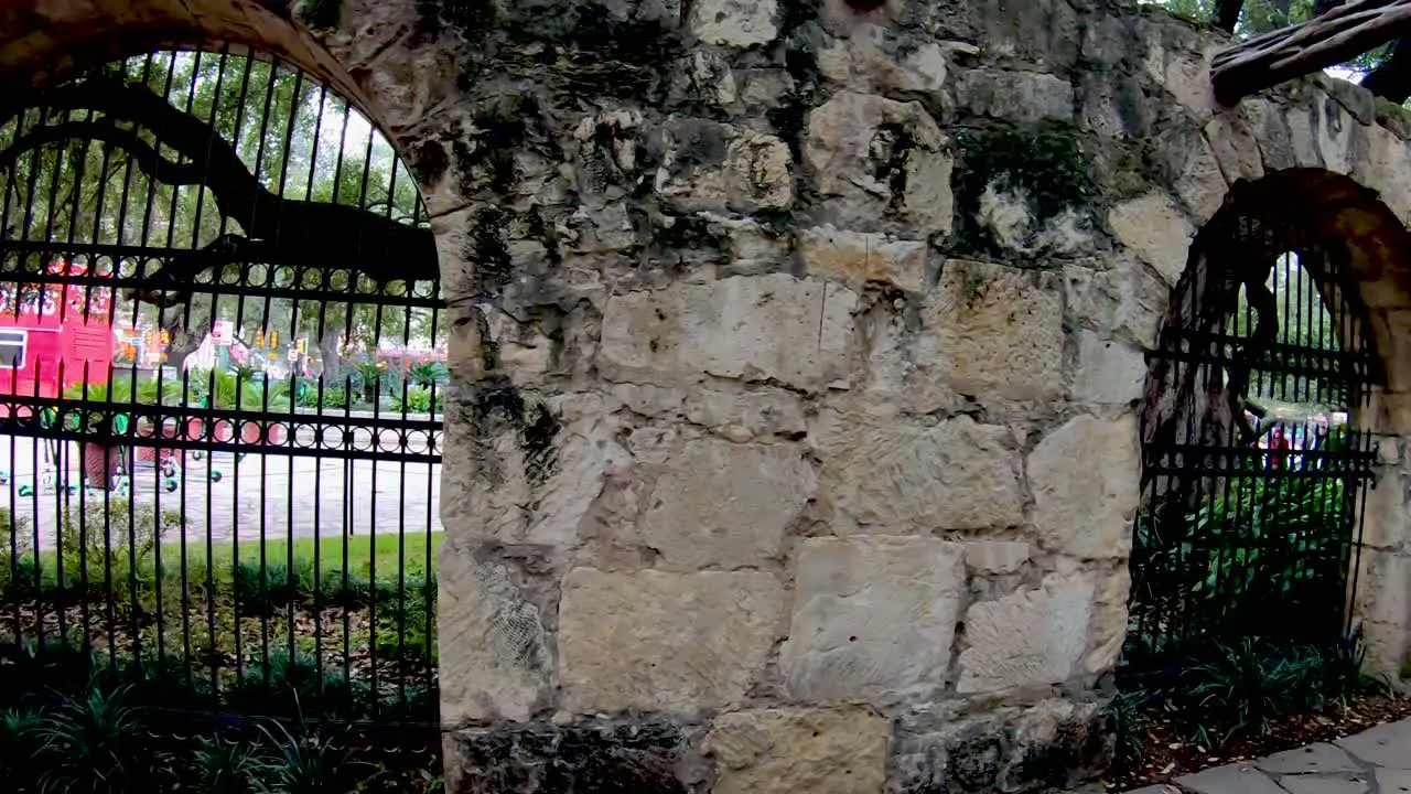 Stone Walls line The Alamo grounds where visitors can learn of the deeds of Davy Crockett and William Travis during the 13 days of the siege and battle for Independence 4K30fps Seg 2 of 2 Slow Motion