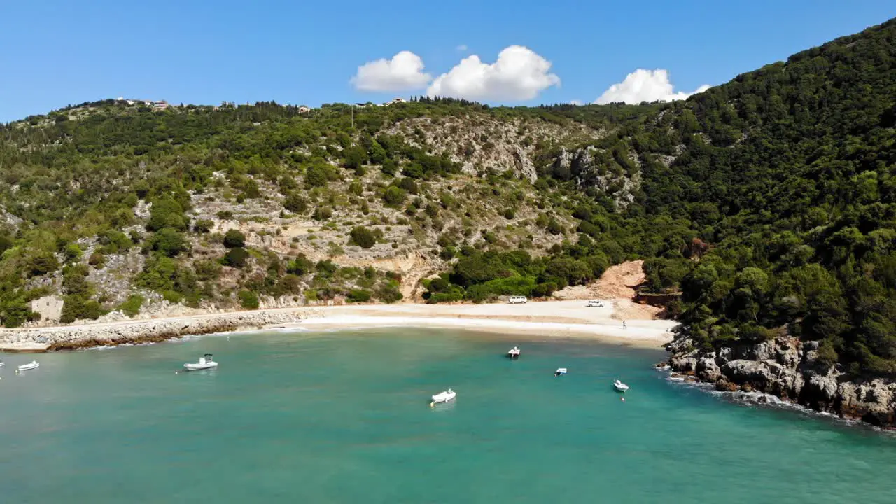 Idyllic Landscape With Boats Floating On The Turquoise Water Of Jerusalem Beach In North Kefalonia Greece aerial drone shot