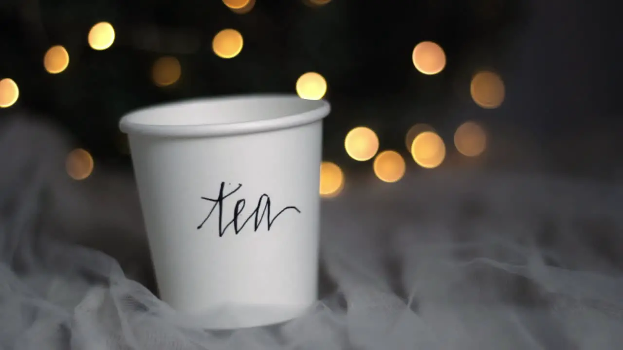 Christmas tea paper cup drink on a cozy netted bed handheld shot