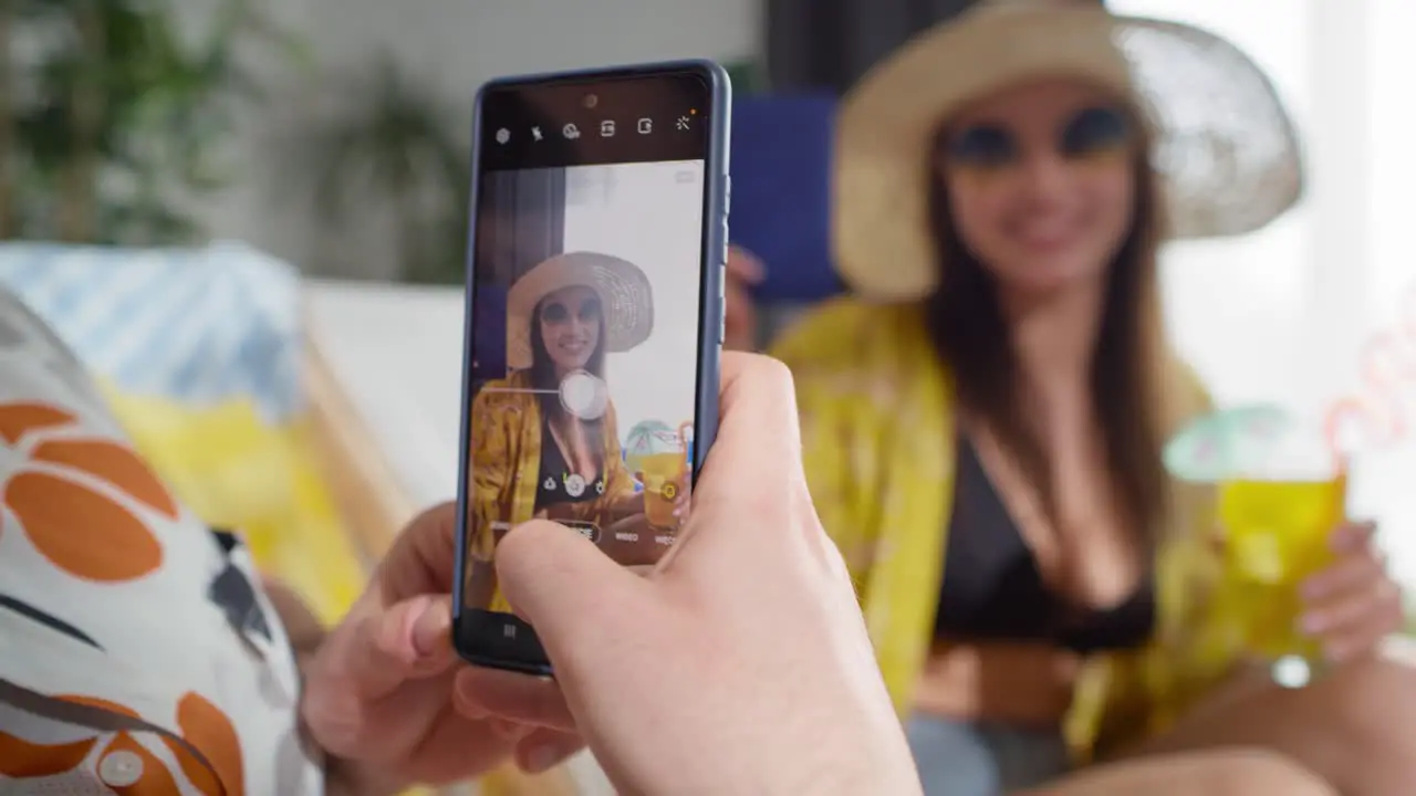 Close up video of man taking a photo of a woman