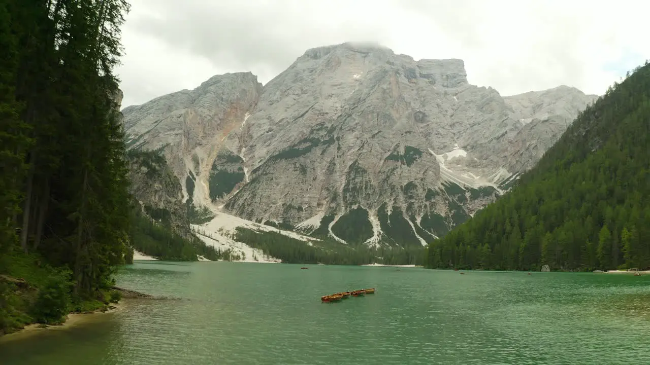 aerial over lago di braies lake in Dolomites mountain range Italy