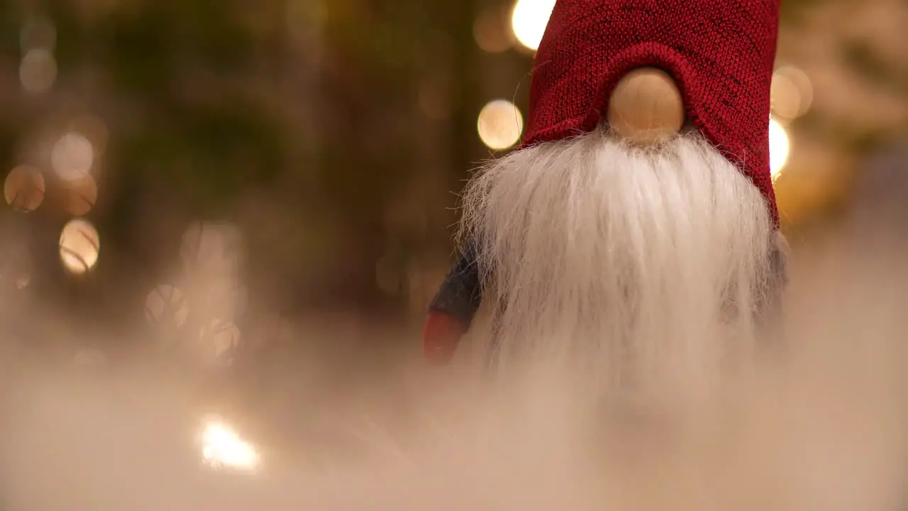 Santa Claus gnome with blurry Christmas Tree in a Dreamy Christmas Scene Close Up