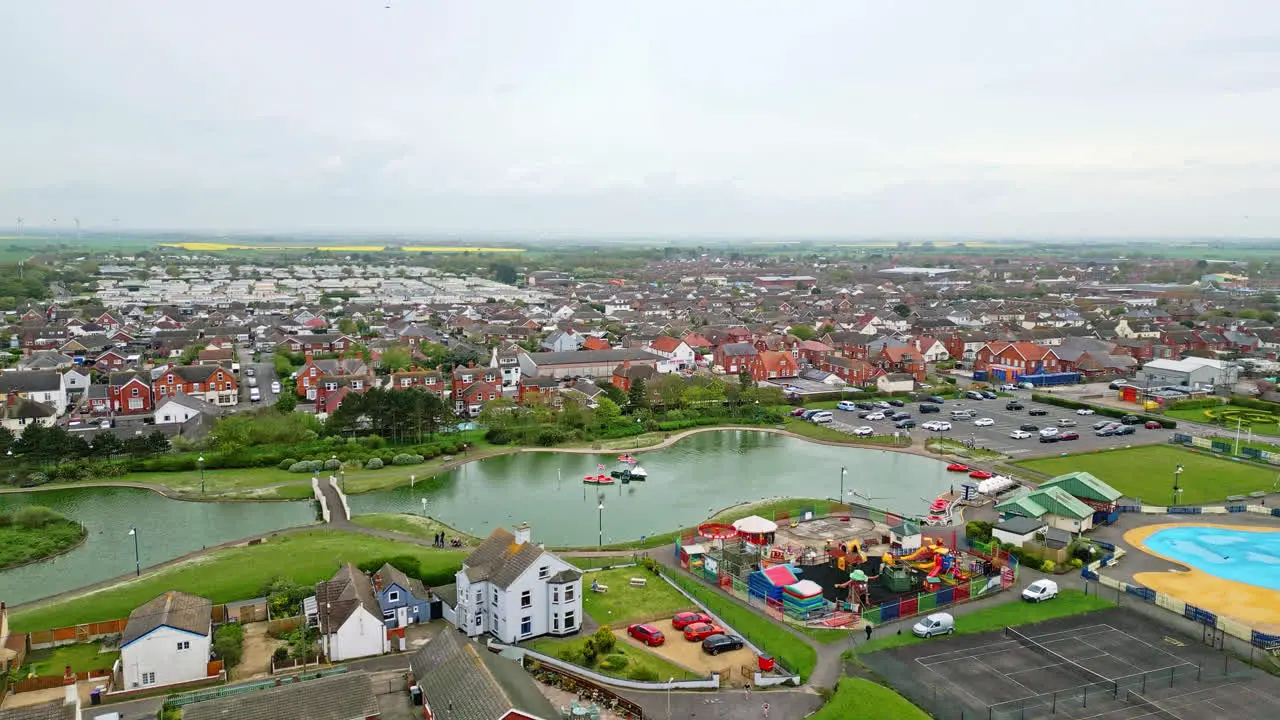 Bird's-eye views of Mablethorpe a Lincolnshire coastal getaway featuring beach huts sandy shores and bustling amusement parks filled with rides and visitors