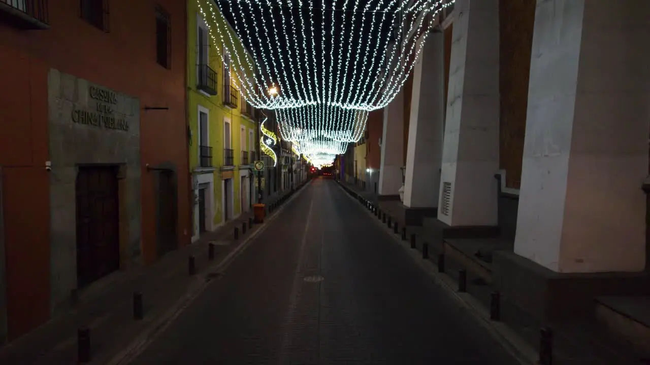 Aerial Push in footage through the streets of Puebla City decorated with Christmas lights