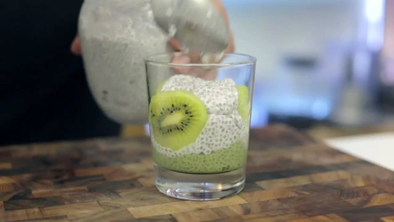 kiwi matcha chia pudding with white coconut chia pudding healthy food being prepared by chef