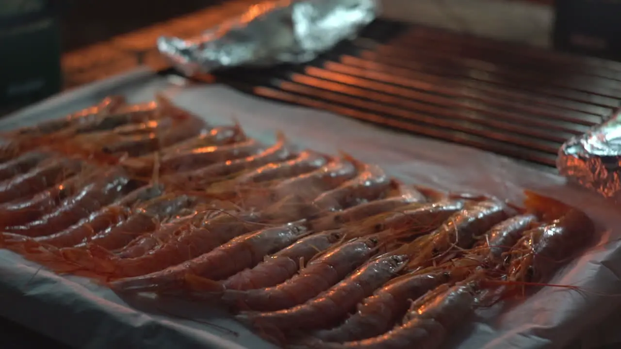 Fresh shrimp roasted on barbecue grill delicious sea food preparation in the dark at evening for dinner