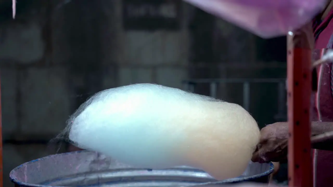 Person making and selling cotton candy in the streets of Guanajuato Mexico