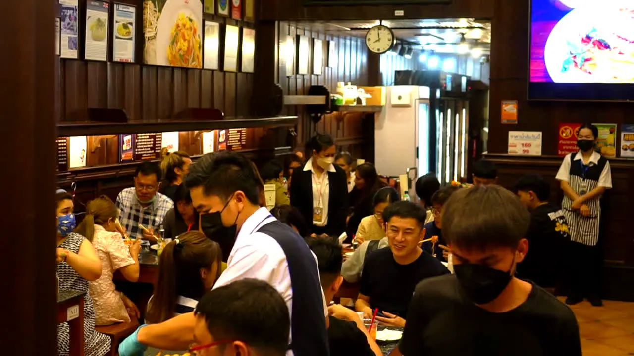 Thailand Bangkok 18 August 2022 Crowded restaurant in Bangkok Thailand with people talking and having fun spending time eating together