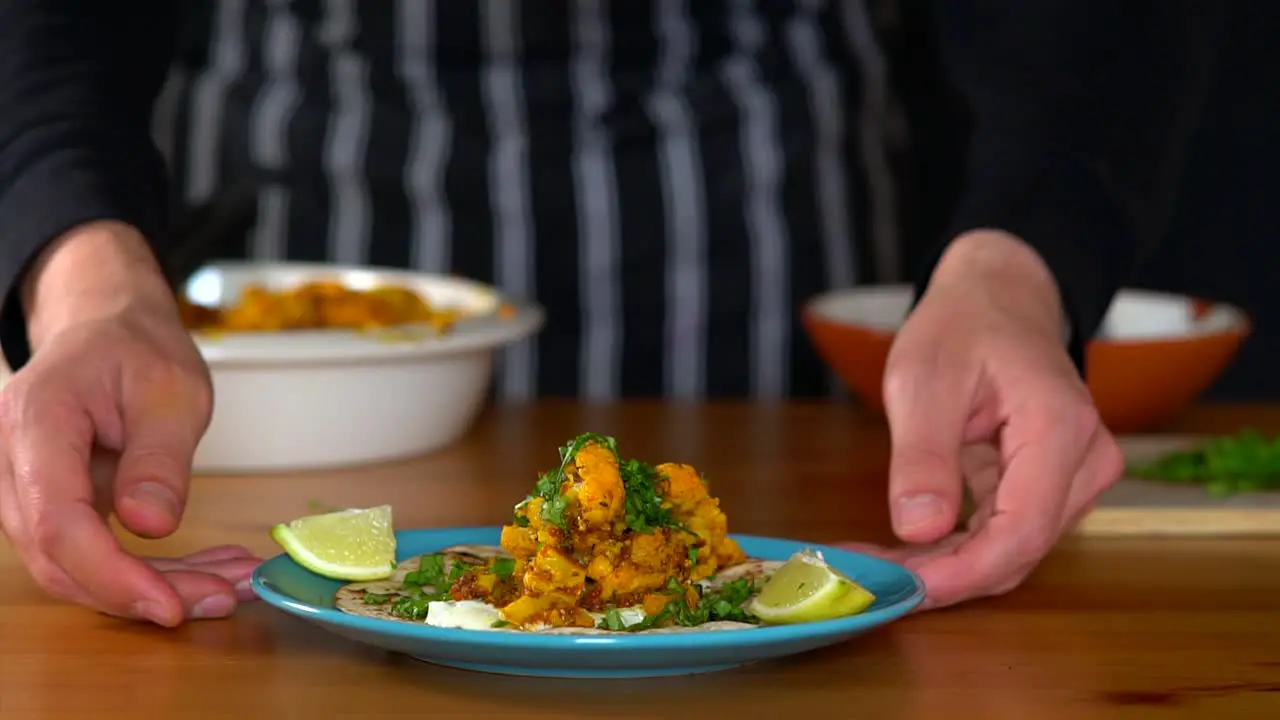 Man Chef presenting tacos and checking the dish if complete