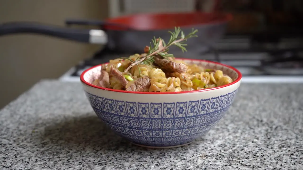 Smoking bowl of pasta with meat pieces