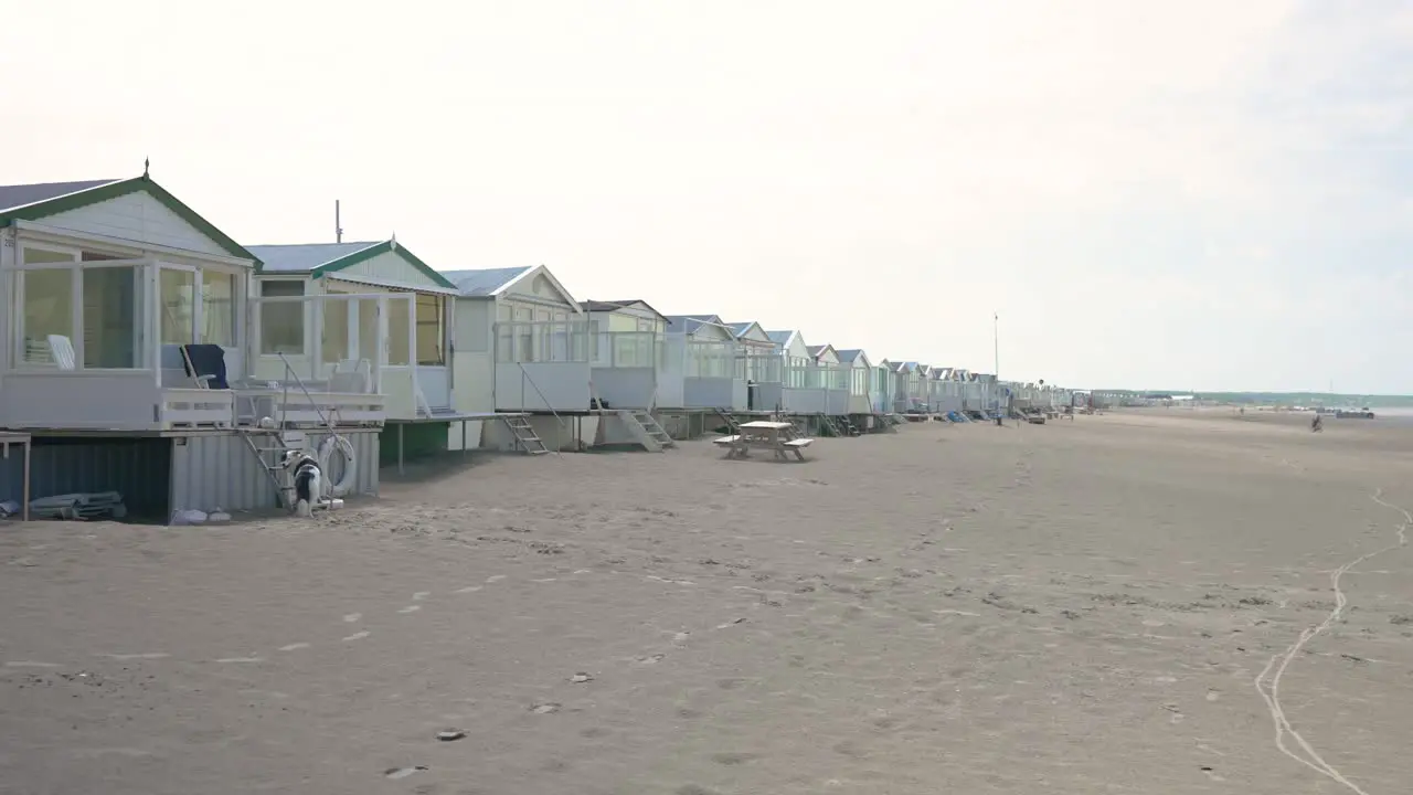 Panning shot of stretch of beach houses in Netherlands