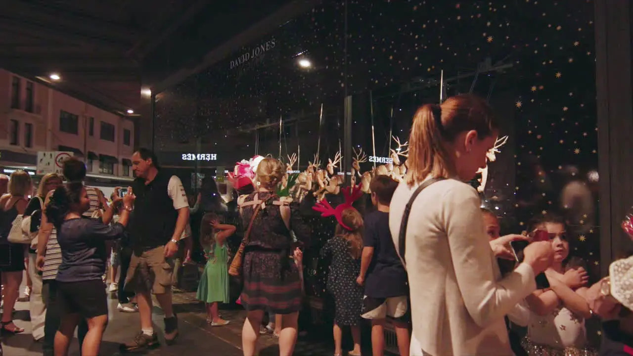 Families gather in crowds to enjoy the holidays at a Christmas display in downtown Sydney Australia