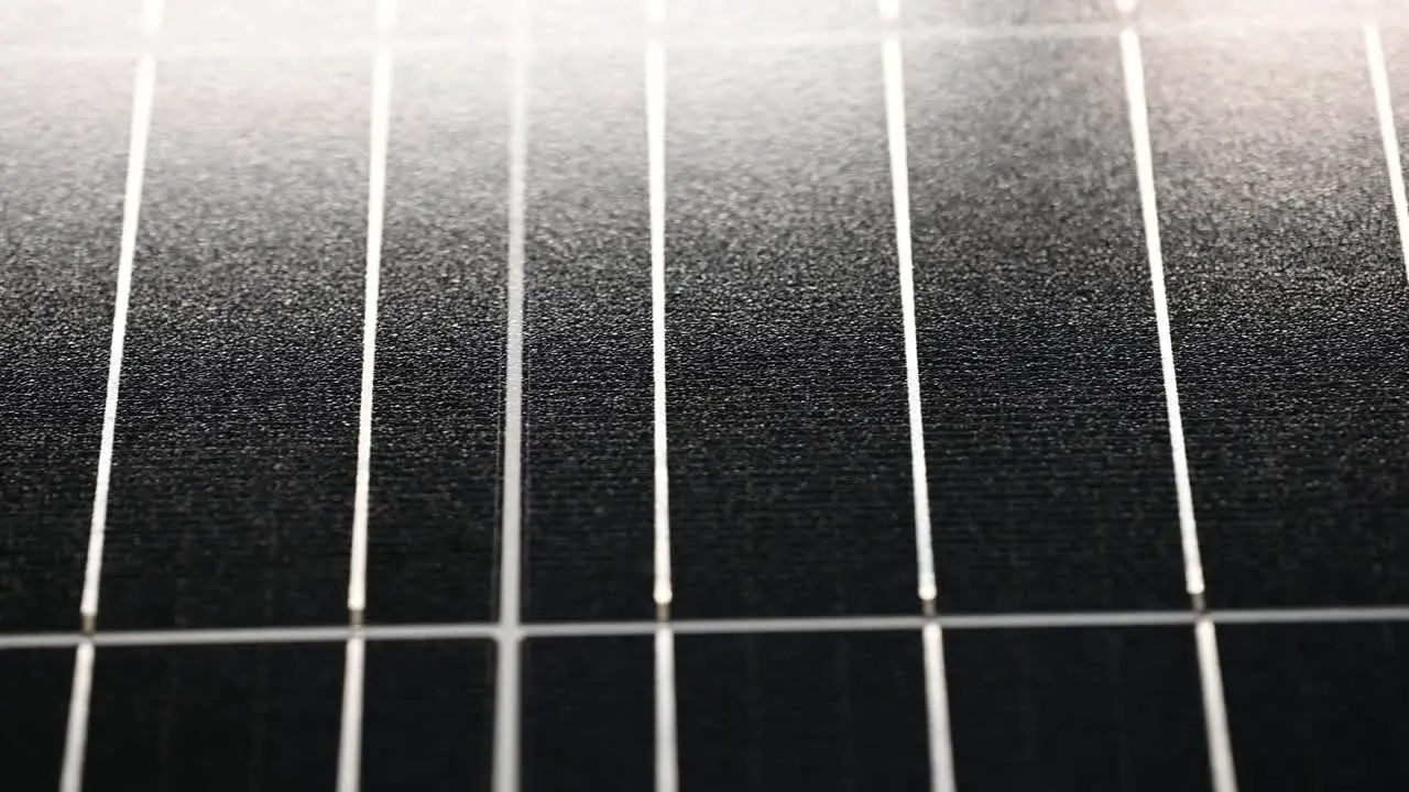 slow close-up of a solar panel sliding right to left in the light