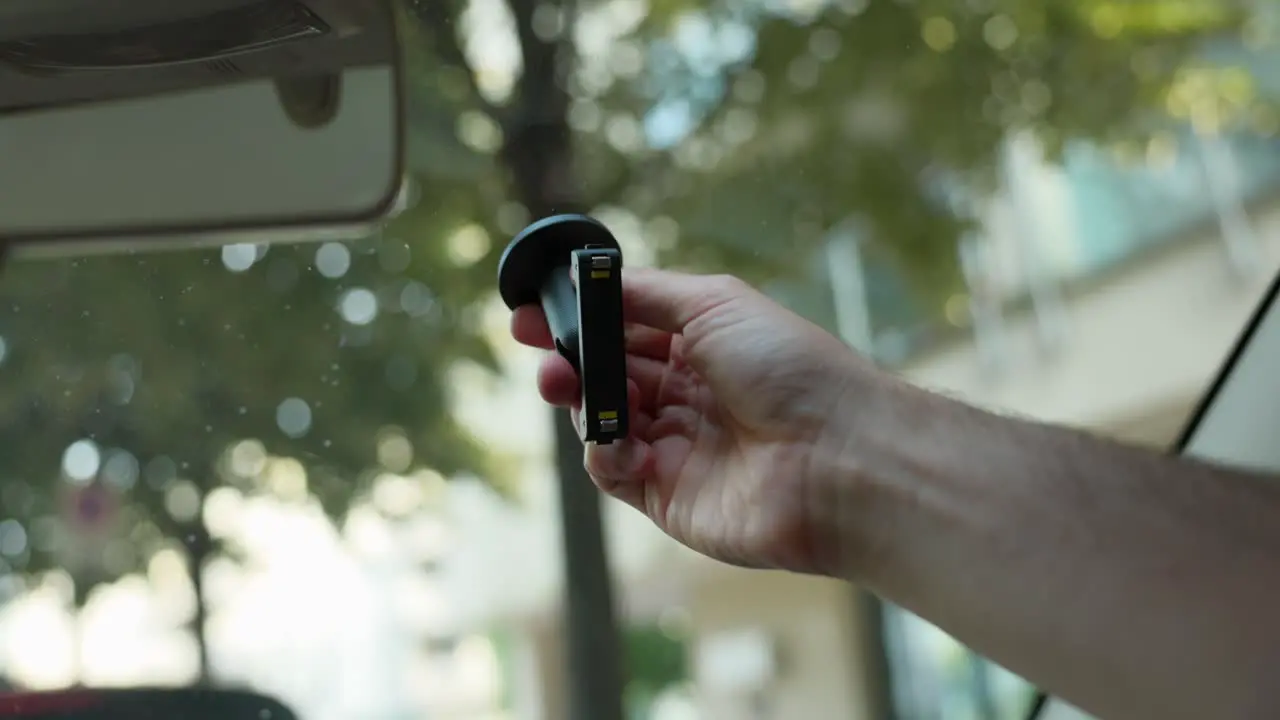 Action Camera Mount Being Placed On Windscreen By Driver