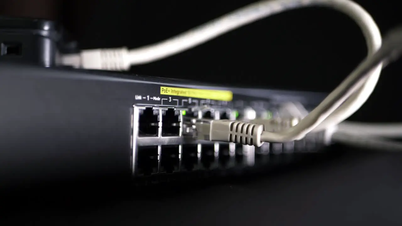 Network switch with Ethernet utp cables panning shot