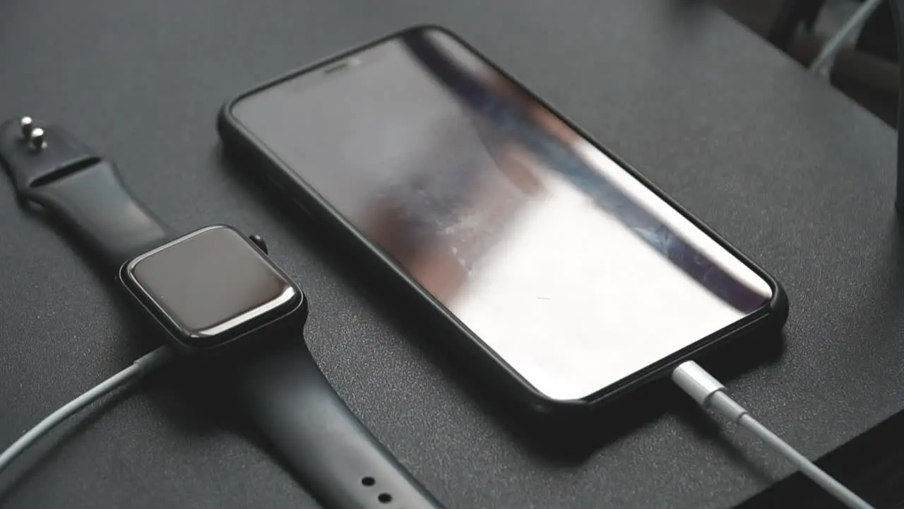 Close up of an iPhone 11 Pro Max and Apple Watch Series 5 on charge