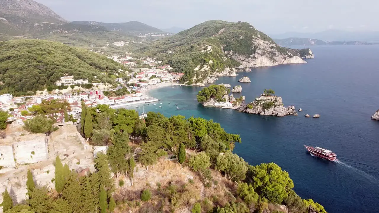 Cruise Boat Sails to Scenic Coastal Village Parga in Epirus Greece Aerial