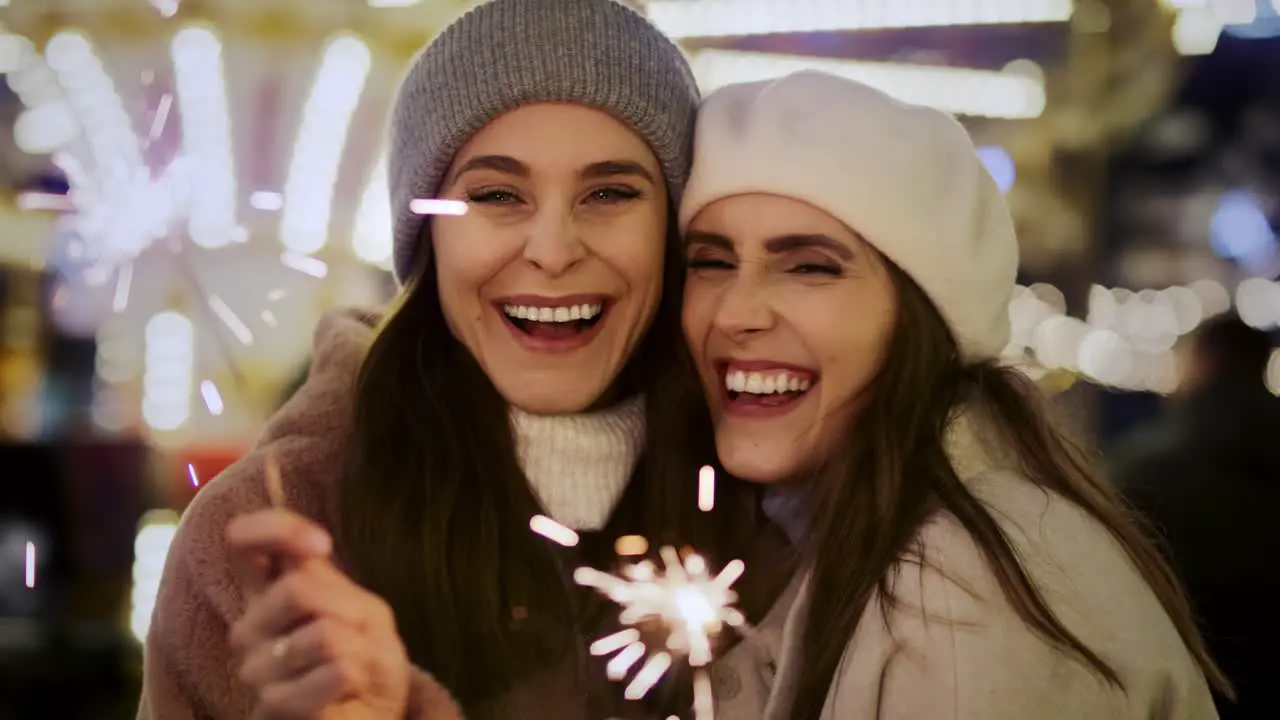 Video of attractive females with sparklers on Christmas market