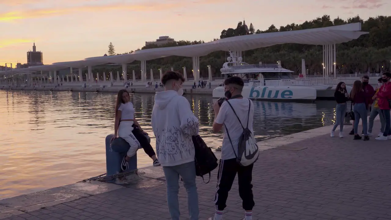 Tourists on Europe Vacation Taking Pictures in Malaga Spain at Sunset