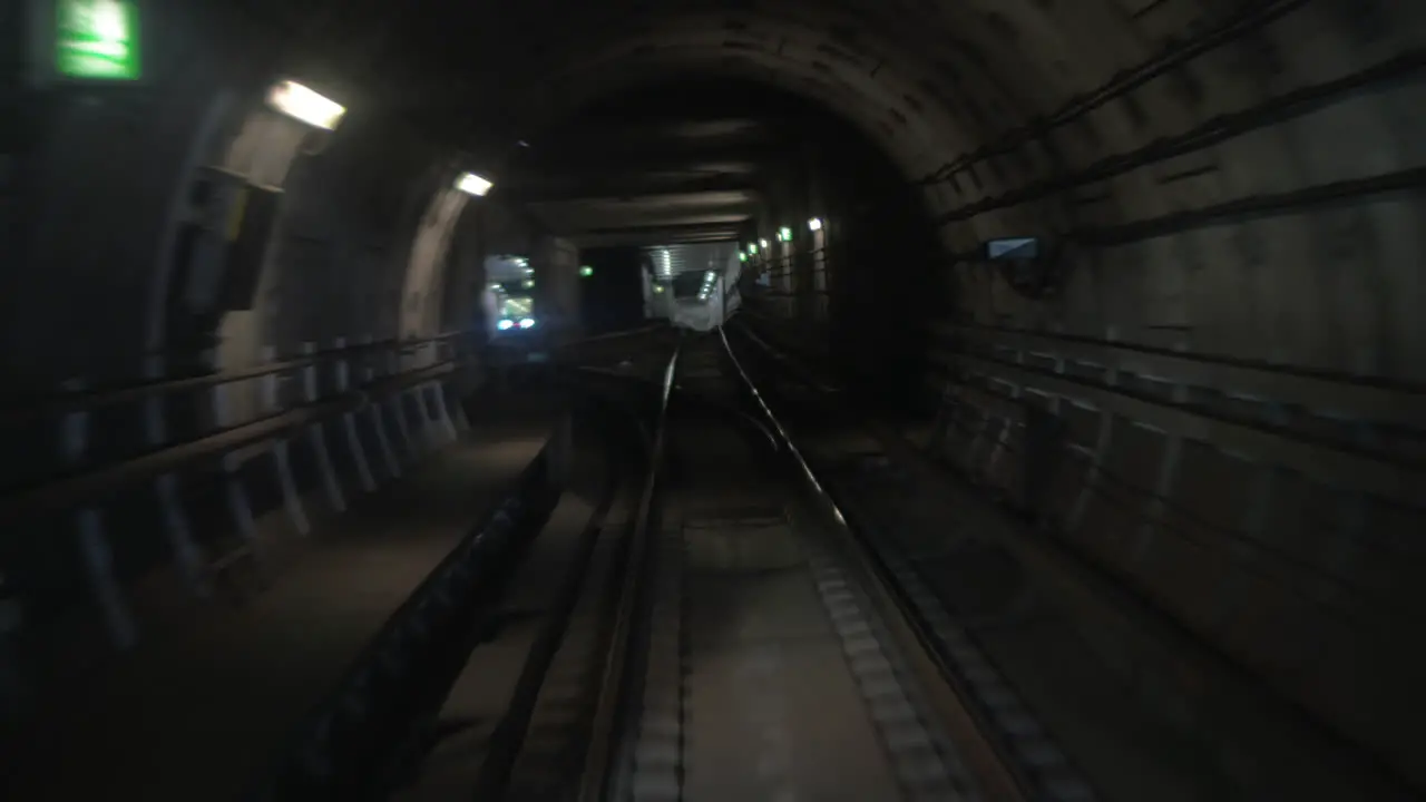 Subway train moving in tunnel and arriving to the station