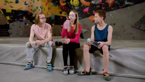 Friends resting in a climbing gym