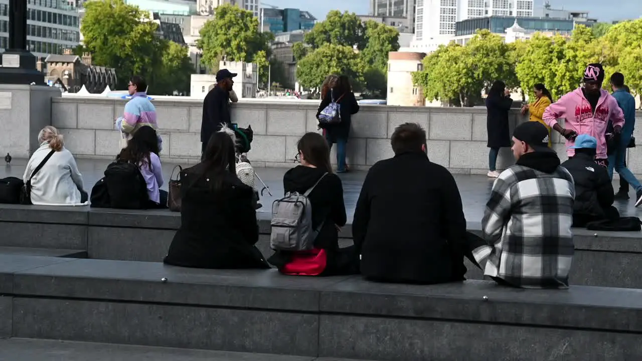 Friends sitting around The Scoop London United Kingdom