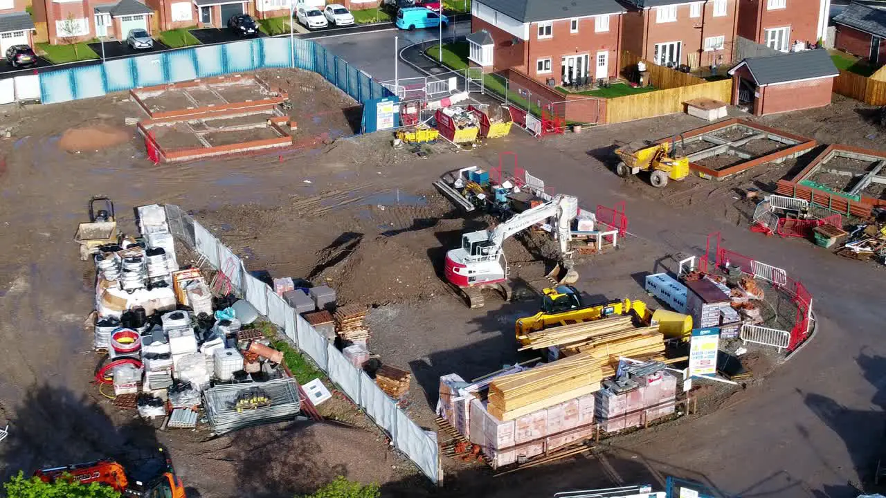 Construction site aerial view above new urban real estate housing development regeneration birdseye push in