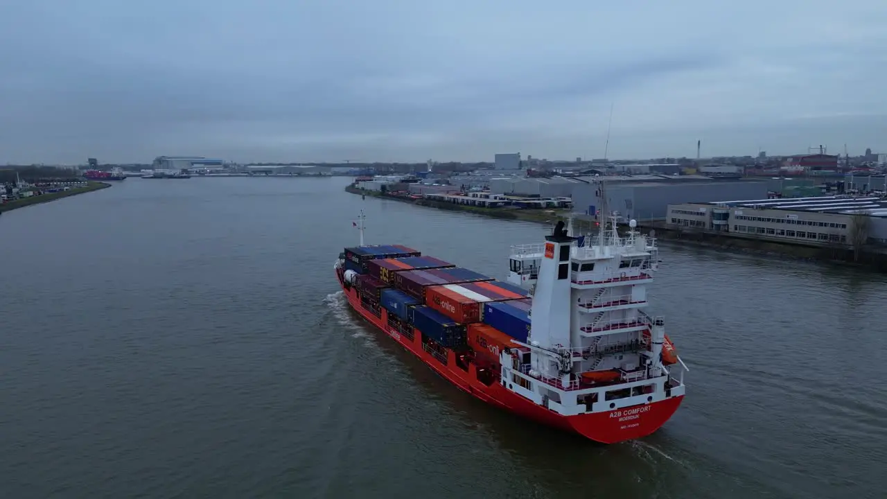 Huge Cargo carrier tanker navigating a fully load through the inland canal of the city Dordrecht