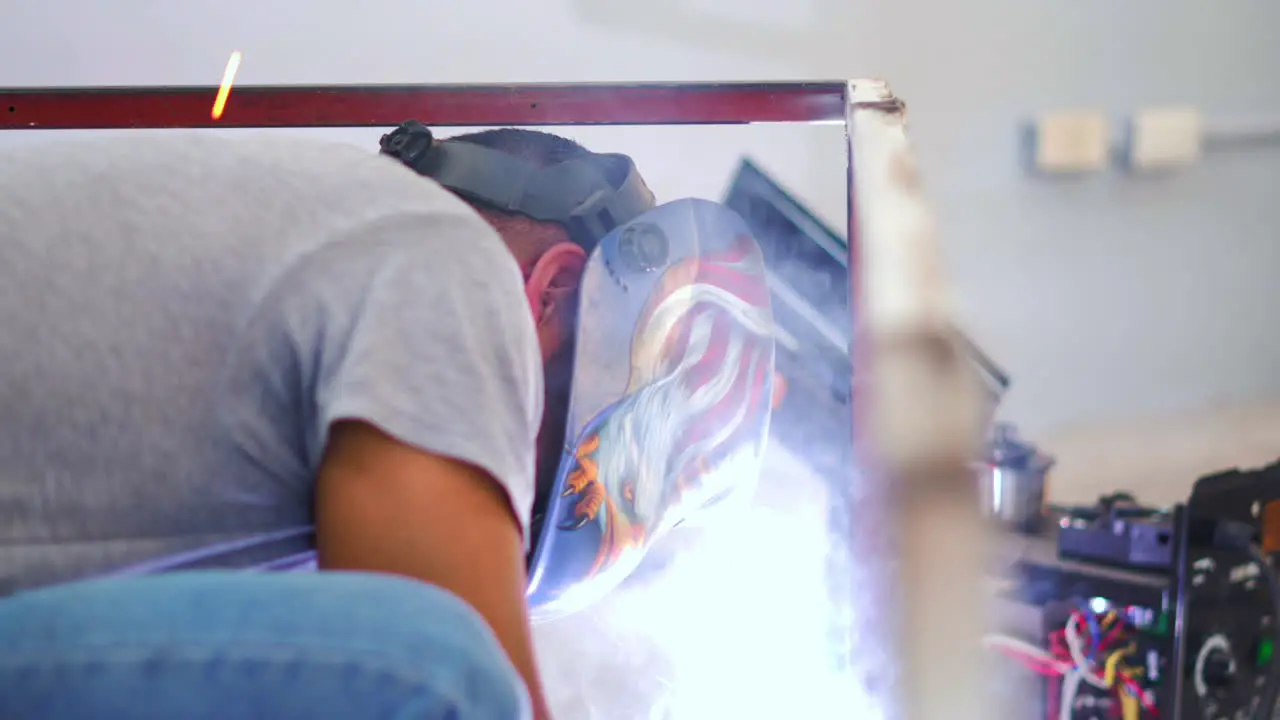 Skilled Welder In Welding Mask Fabricating Steel Frame In A Workshop