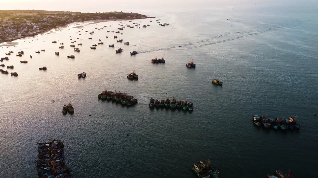 Sunset drone traditional fishing vessels anchored in bay