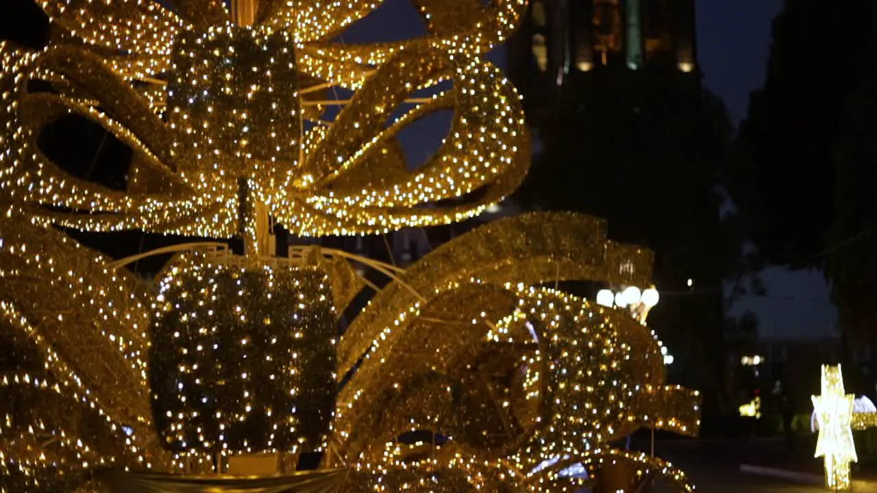 Tilt up camera footage of the Christmas tree of the main square of Puebla city and the Cathedral in the background