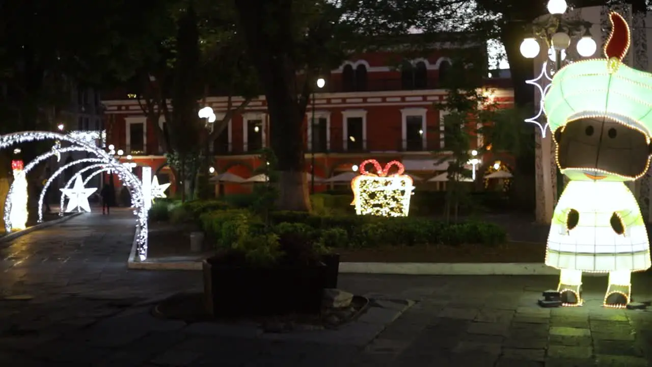 pan footage of Christmas lights and decorations in the main park of Puebla City mx