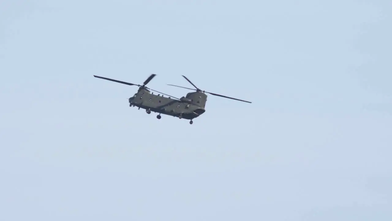 Zoom Shot of Boeing Chinook Flying in Slow Motion With Birds Flying Through Frame