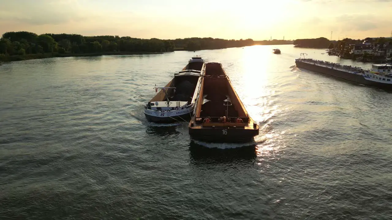 Ship traffic on wide river at sunset