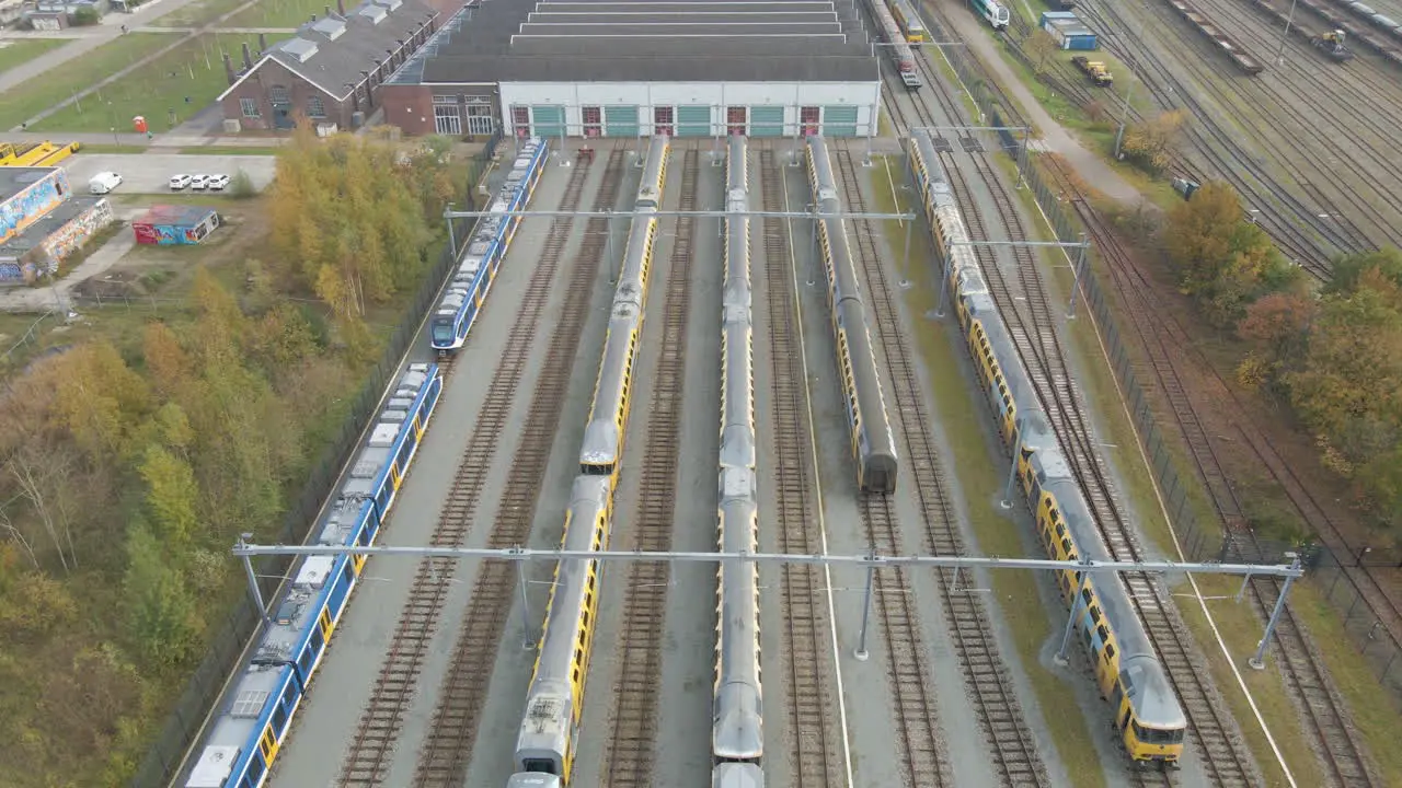 Aerial of trains parked in front of workshop at train yard