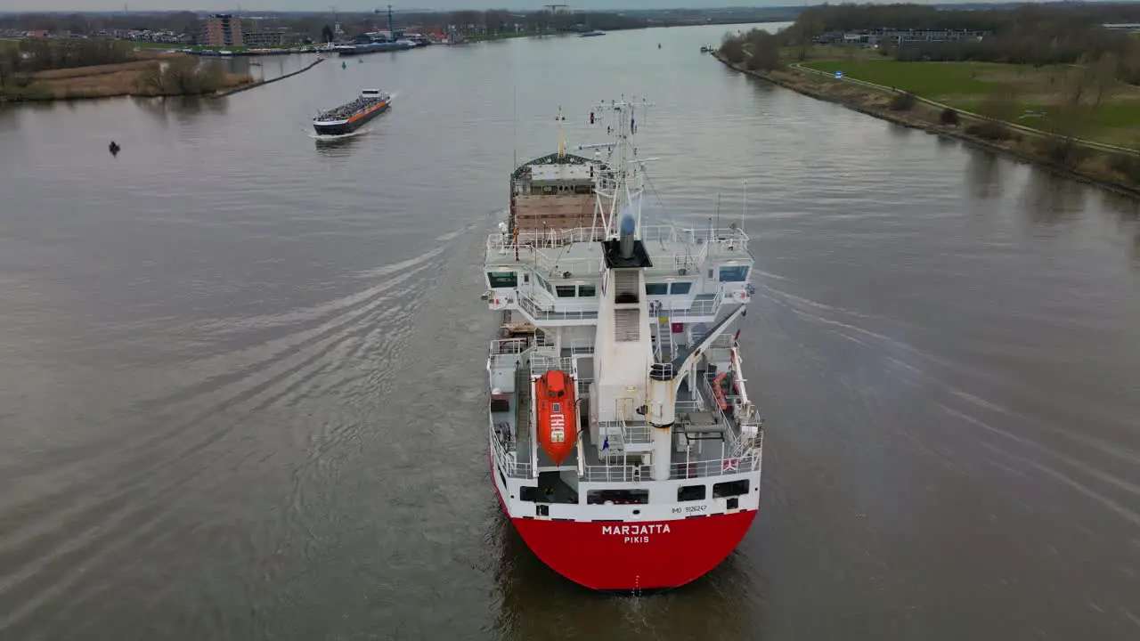 Empty container ship "Marjatta" navigating through the city canal of Zwijndrecht aerial view