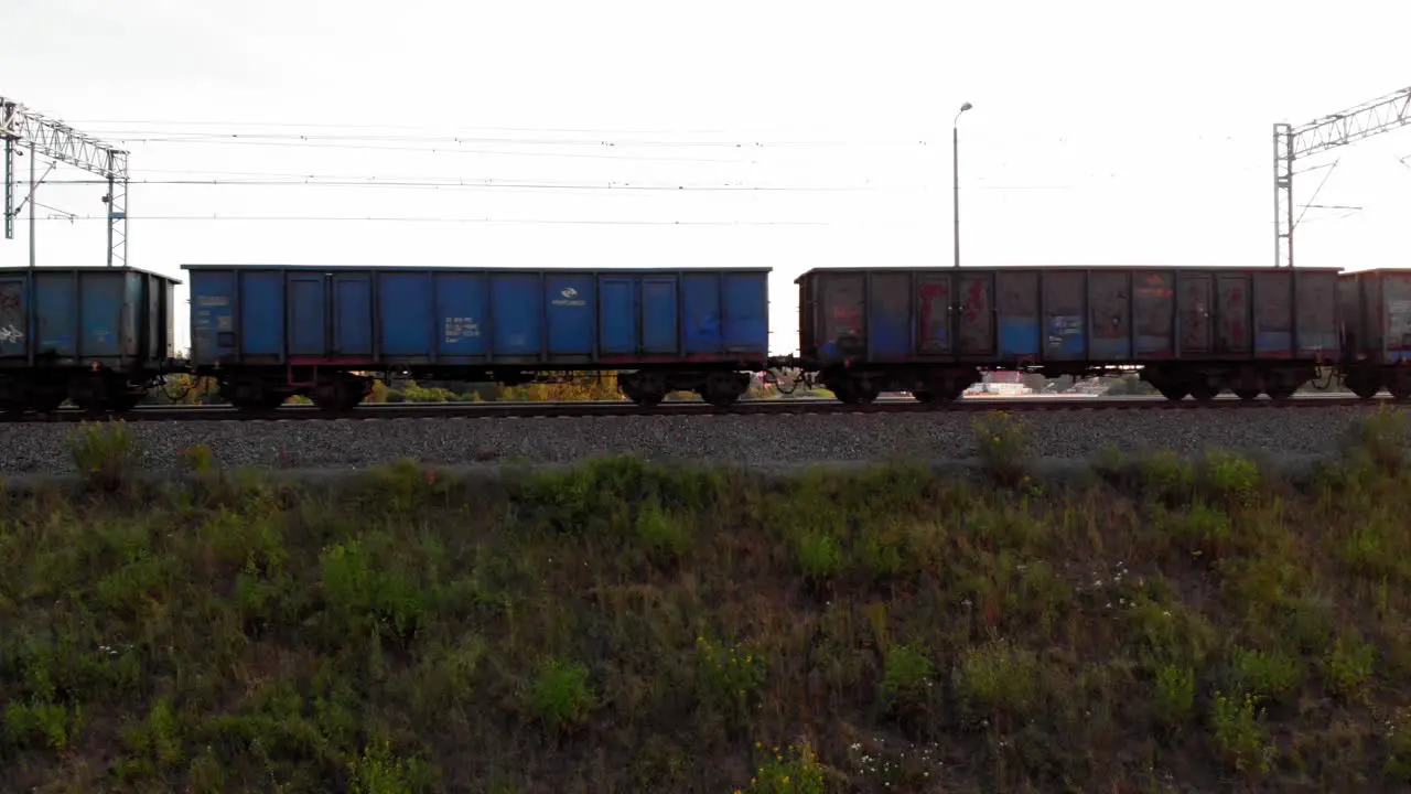 Train With empty Cargo Containers Moving Down Tracks