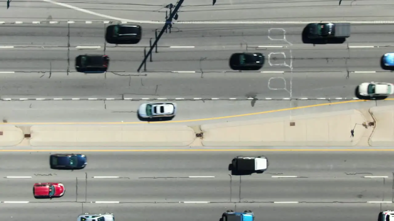 Six lanes of traffic aerial traffic on busy highway expressway commuters during daytime travel