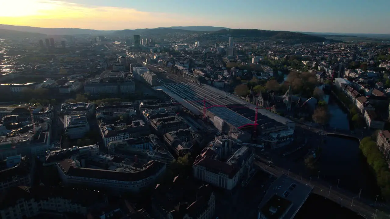 Stunning aerial drone view of Zurich cityscape flying above train station