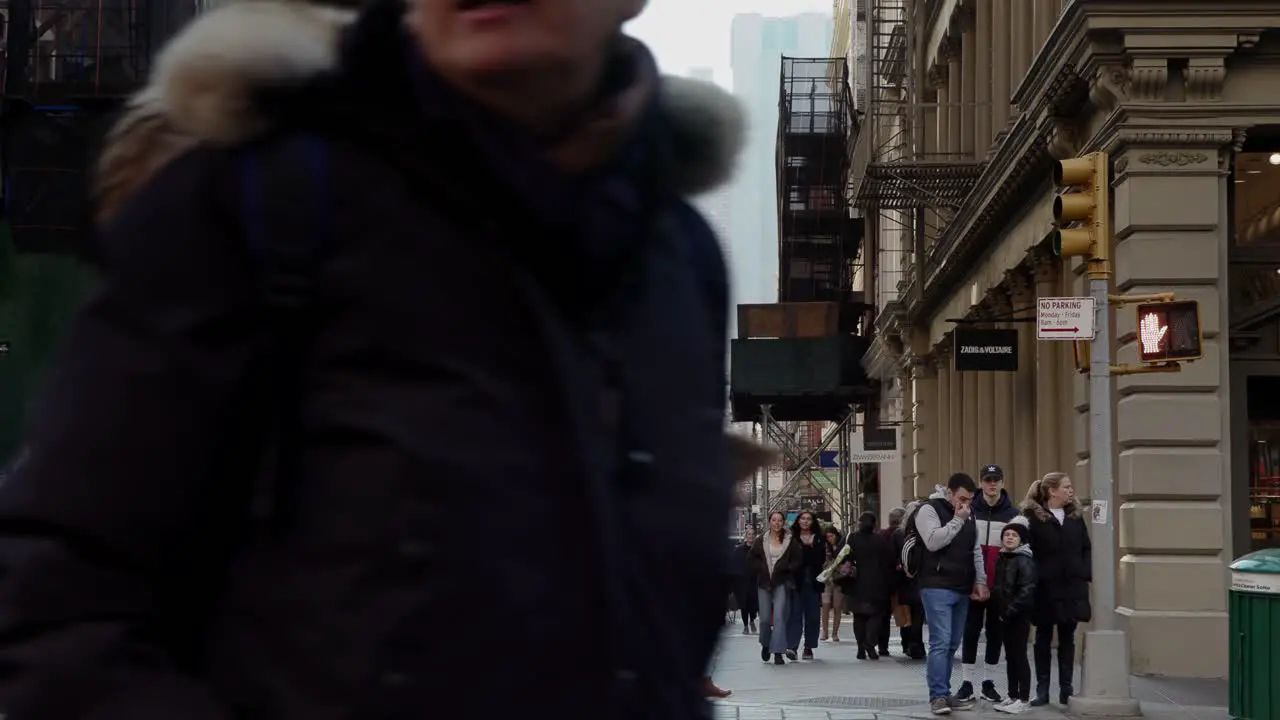 People walking on crossroad in Soho New York