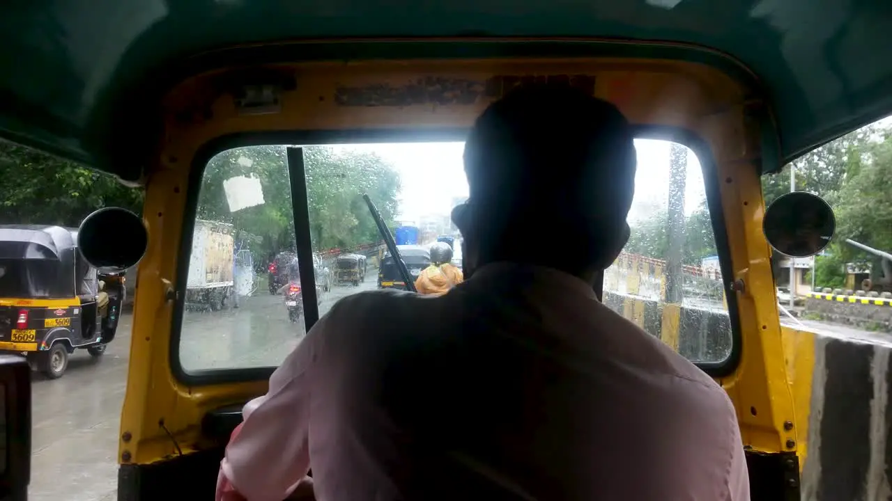 View Behind A Tuk Tuk Driver Travelling On The Street In Mumbai India On A Rainy Weather Passenger's POV Shot