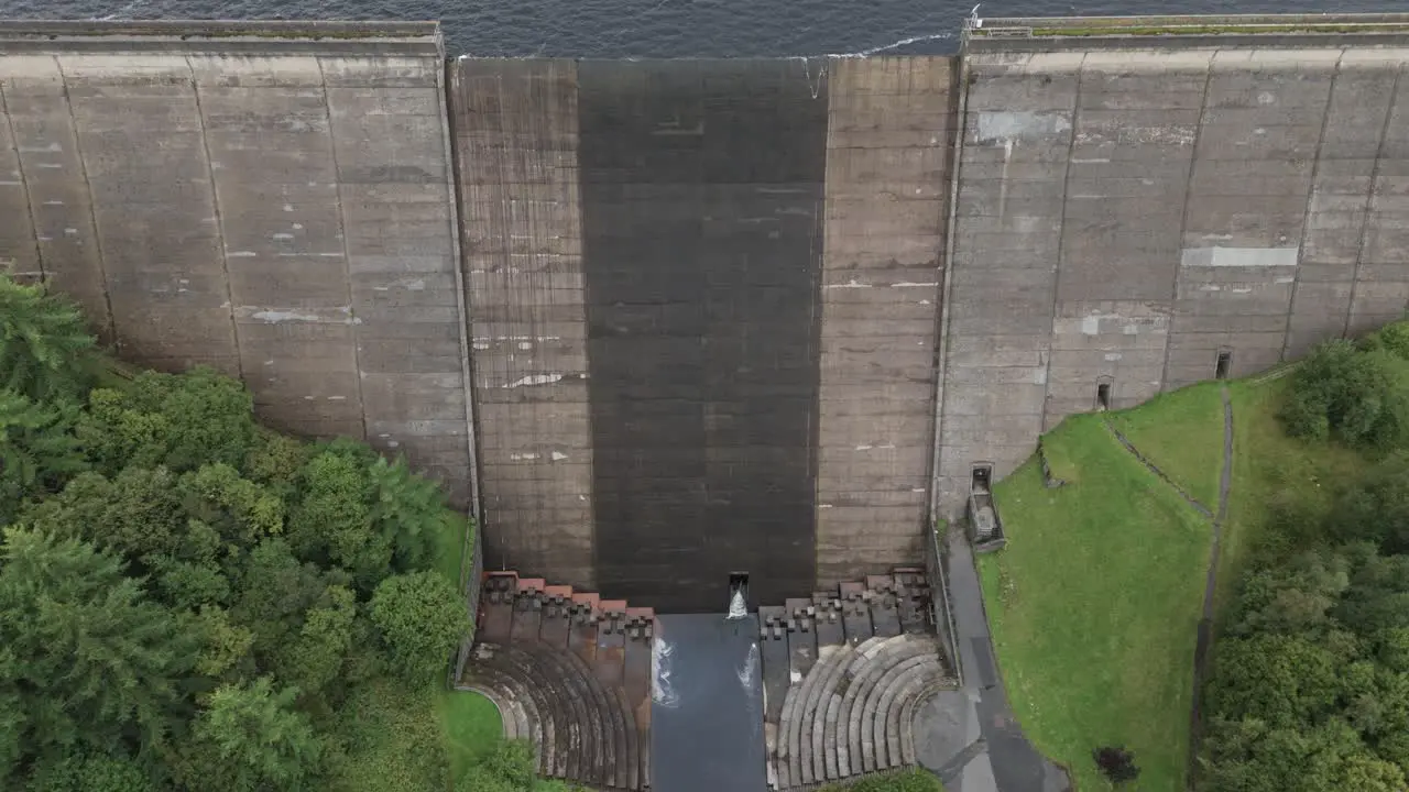 Booth wood reservoir aerial view slowly descending the concrete dam spillway gate in West Yorkshire