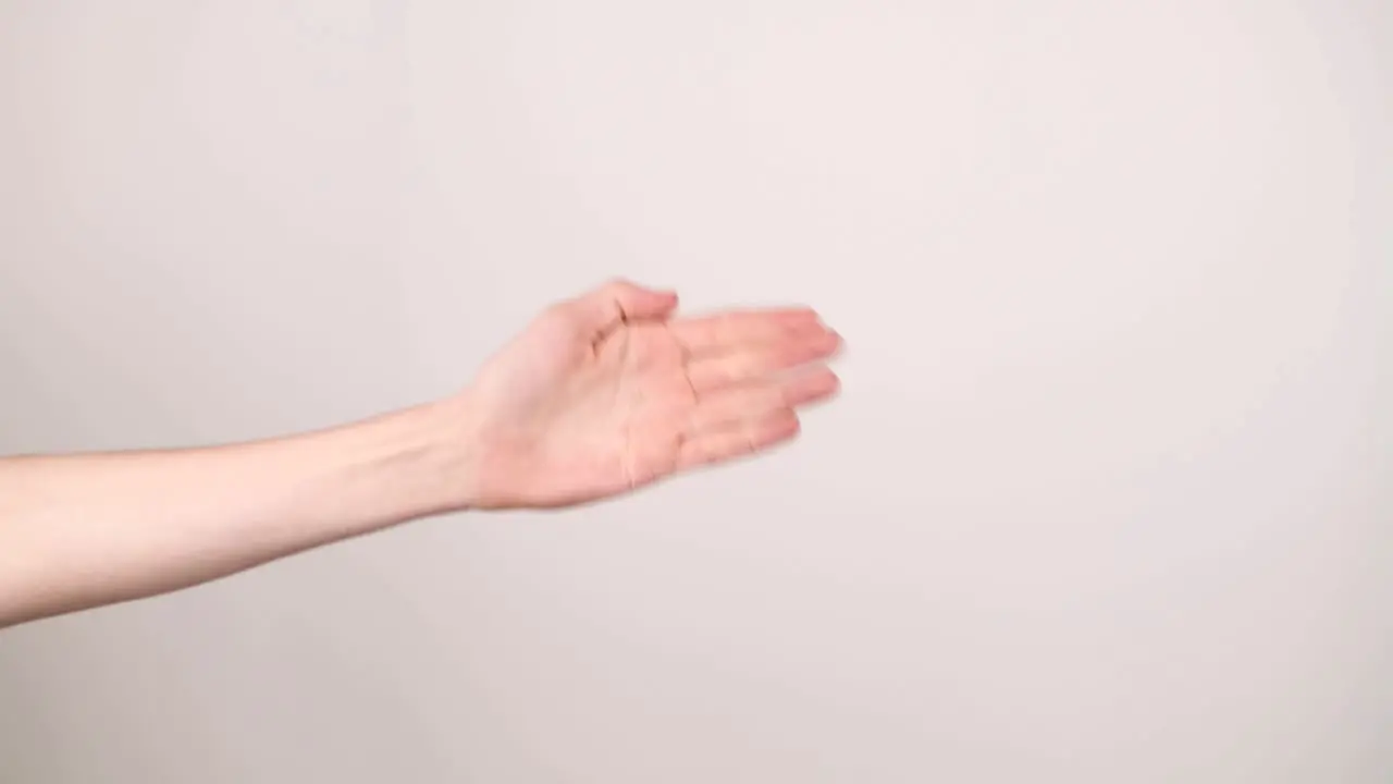 A hand on the left side doing rock paper scissors on a white background